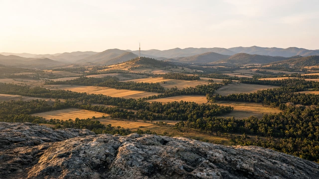 Farmland and distant ranges from a granite lookout near Mount Barker